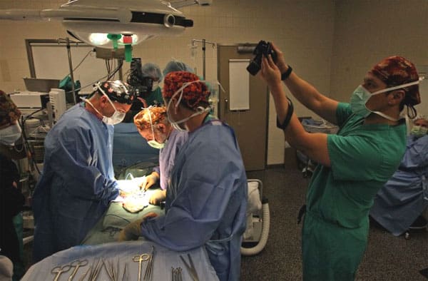 Dr. Sherman Silber “quilts” strips of previously frozen ovarian tissue together before he grafts them onto the existing ovary inside patient Jenny Remington-Hobbs at St. Luke’s Hospital in Chesterfield on Oct. 12, 2012. Dr. Sonny John Stetson (right) documents the procedure.